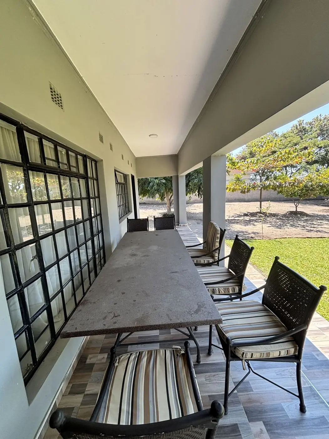 Veranda with tiled floor and steel-framed windows