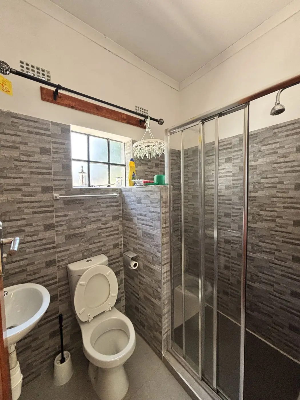 Bathroom with full-height wall tiling and glass shower enclosure