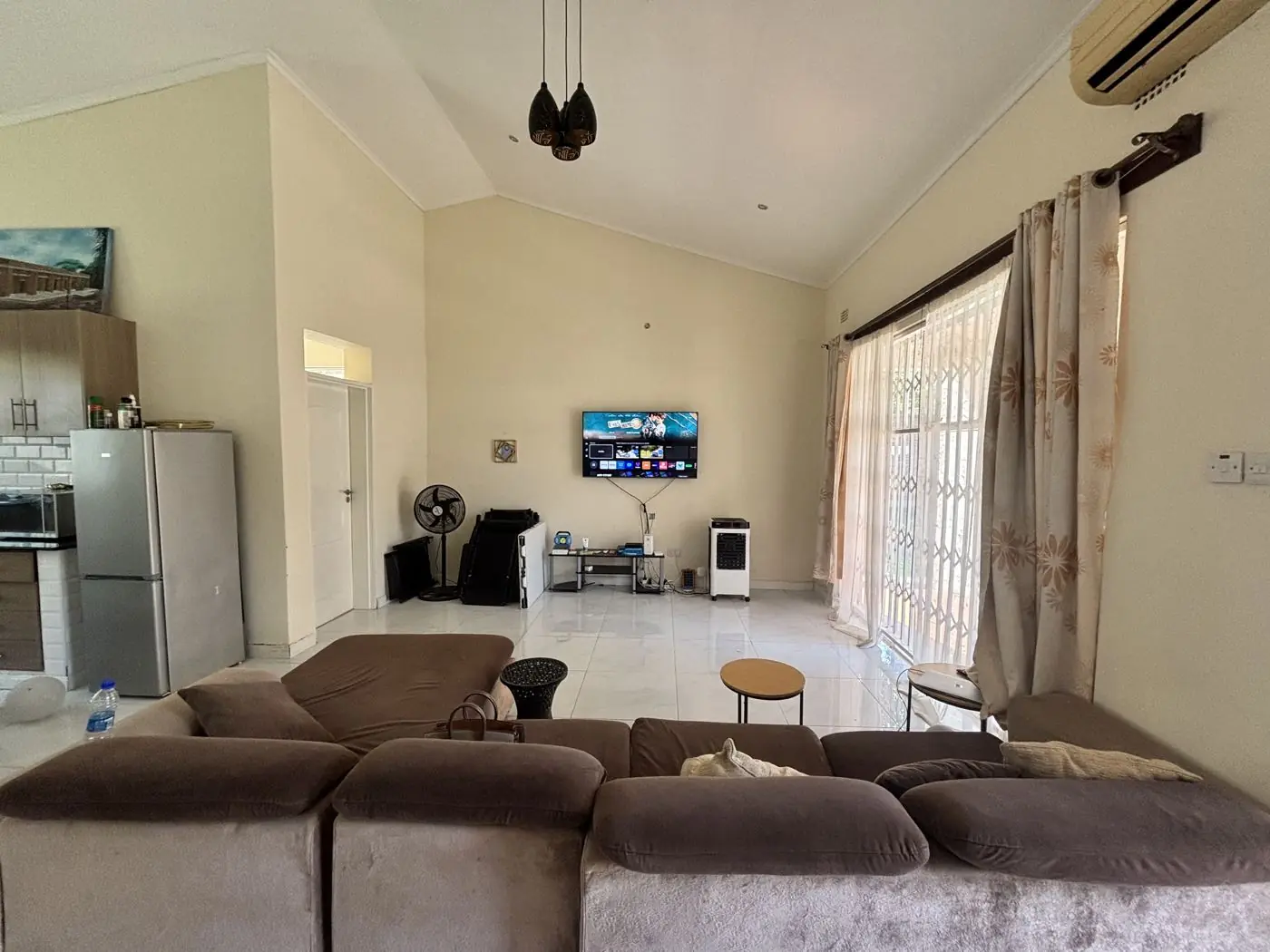 Living area with vaulted ceiling and tiled floor