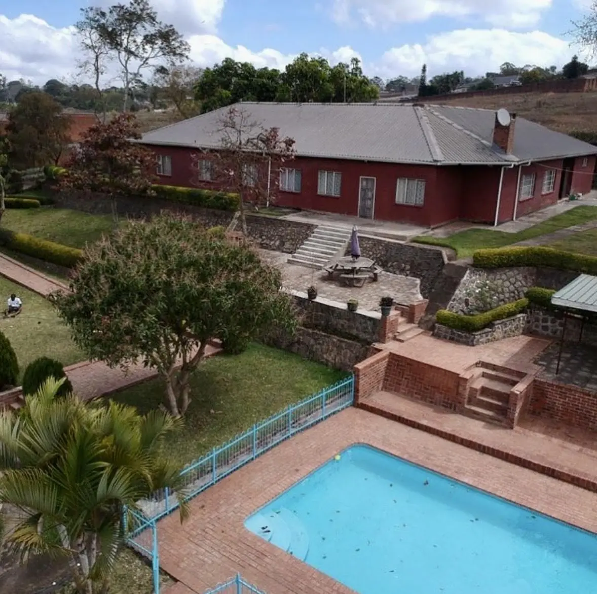 Residential property with pool, brick terraces and landscaped gardens